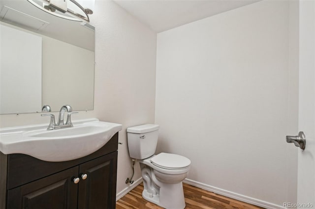 bathroom featuring vanity, toilet, and wood-type flooring