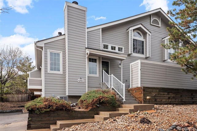 4882 W 68th Ave Unit 4, Westminster, CO 80030 - view of front of home with a chimney and fence
