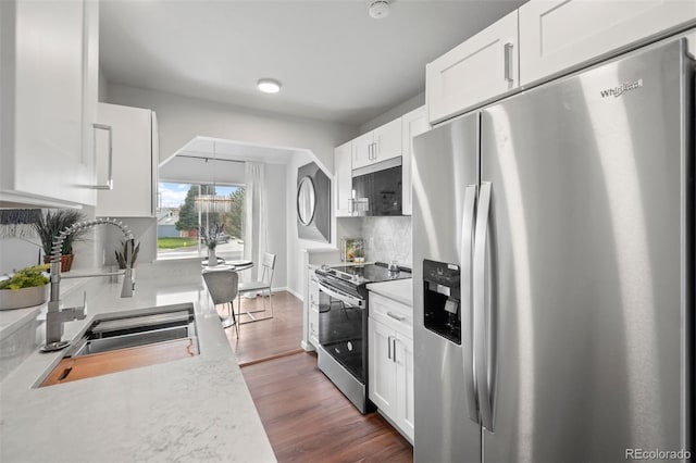 4882 W 68th Ave Unit 4, Westminster, CO 80030 - kitchen with stainless steel appliances, a sink, light countertops, and backsplash