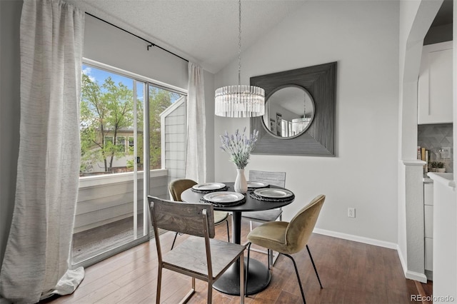 4882 W 68th Ave Unit 4, Westminster, CO 80030 - dining area featuring lofted ceiling, a chandelier, wood finished floors, a textured ceiling, and baseboards