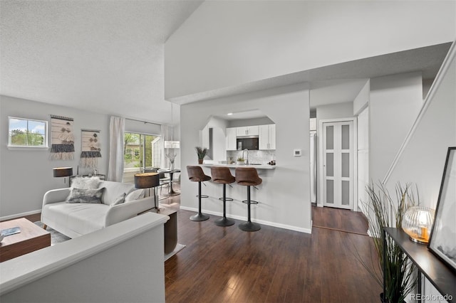4882 W 68th Ave Unit 4, Westminster, CO 80030 - living area with dark wood finished floors and baseboards