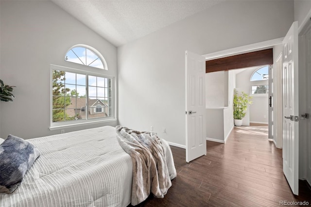 4882 W 68th Ave Unit 4, Westminster, CO 80030 - bedroom featuring wood finished floors, lofted ceiling, baseboards, and a textured ceiling