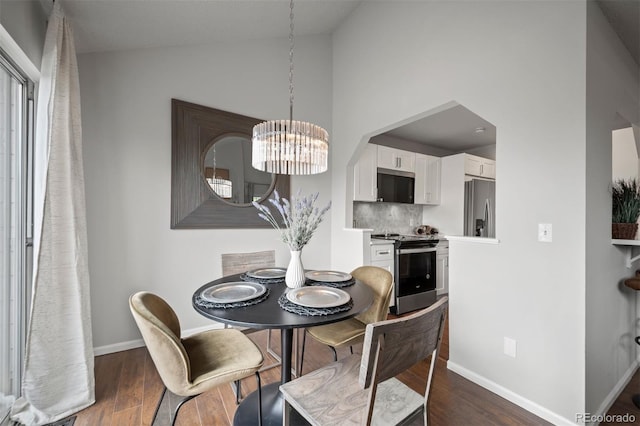 4882 W 68th Ave Unit 4, Westminster, CO 80030 - dining room with dark wood finished floors, a chandelier, baseboards, and high vaulted ceiling