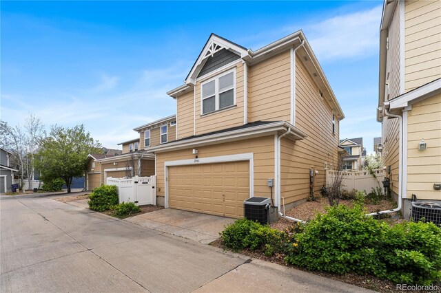 2846 Central Park Blvd, Denver, CO 80238 - view of front facade featuring a garage, central AC, and concrete driveway