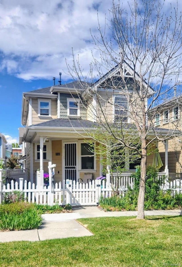 2846 Central Park Blvd, Denver, CO 80238 - view of front of home with a fenced front yard and a porch