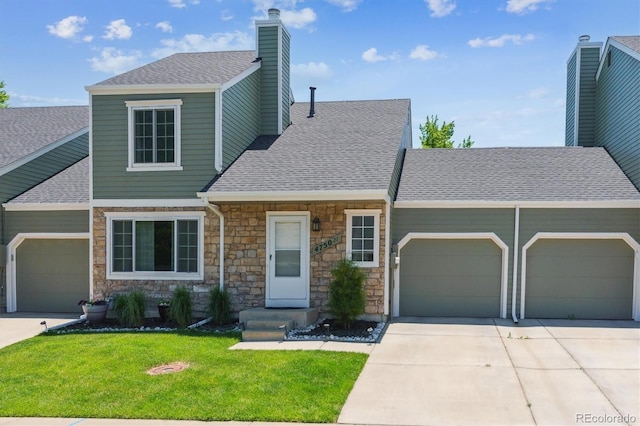 4750 S Dudley St Unit 21, Littleton, CO 80123 - view of front of property featuring a garage, roof with shingles, stone siding, a chimney, and a front lawn