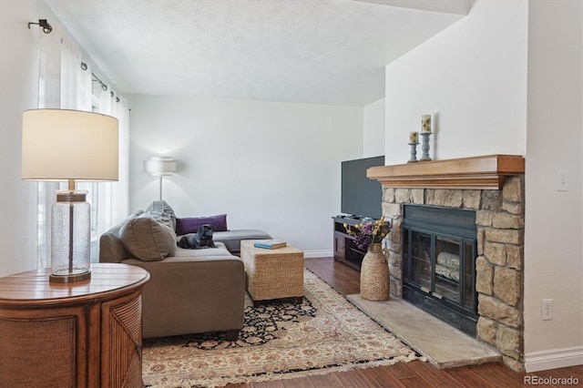 4750 S Dudley St Unit 21, Littleton, CO 80123 - living area with wood finished floors and a stone fireplace