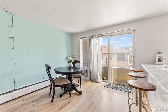 75 N Emerson St Unit 206, Denver, CO 80218 - dining area featuring wood finished floors and a baseboard radiator