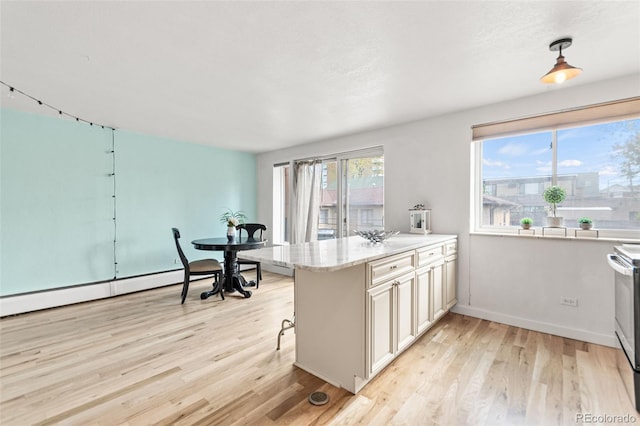 75 N Emerson St Unit 206, Denver, CO 80218 - kitchen featuring light wood-style flooring, a peninsula, baseboards, light stone counters, and electric range oven