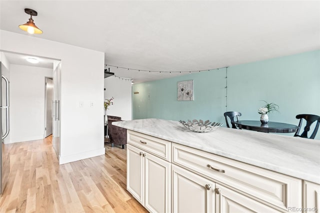 75 N Emerson St Unit 206, Denver, CO 80218 - kitchen featuring light wood-style flooring and baseboards