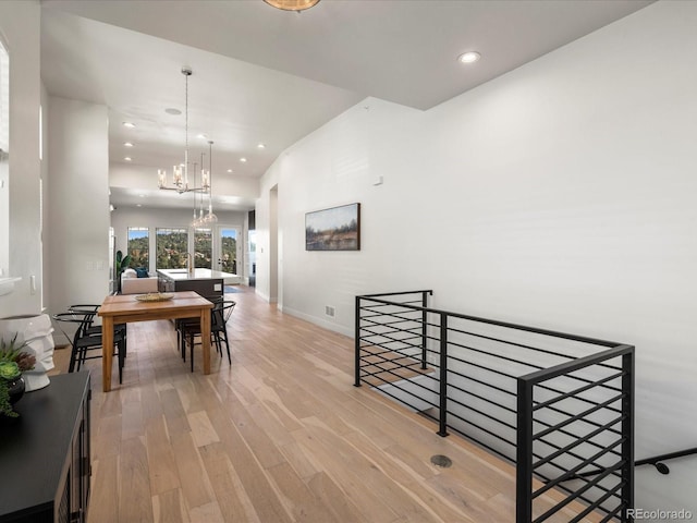 interior space with an inviting chandelier and light hardwood / wood-style flooring