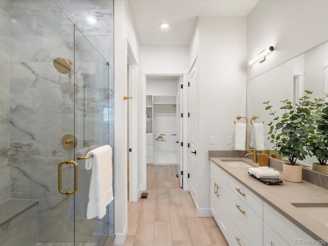 bathroom featuring vanity, a shower with door, and hardwood / wood-style floors