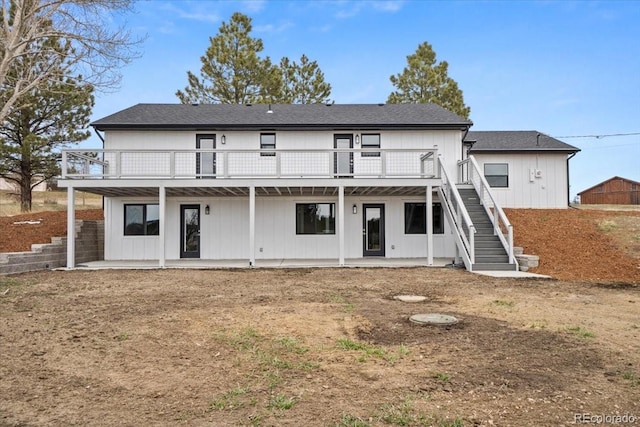 11840 Elkhorn Dr, Franktown, CO 80116 - back of house with stairway, a deck, and a patio area