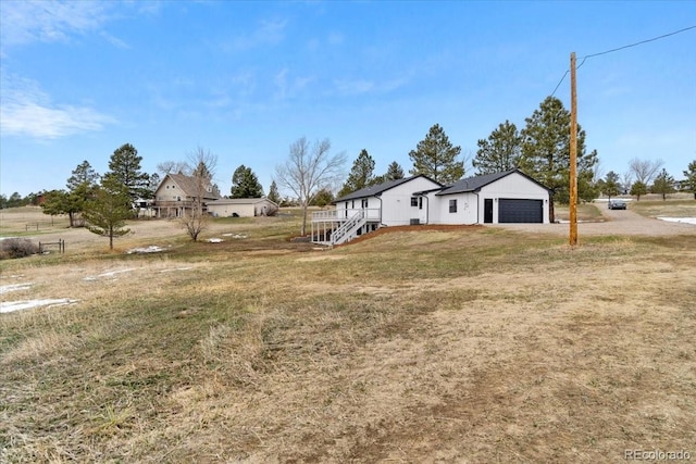 11840 Elkhorn Dr, Franktown, CO 80116 - view of green lawn with an attached garage and driveway