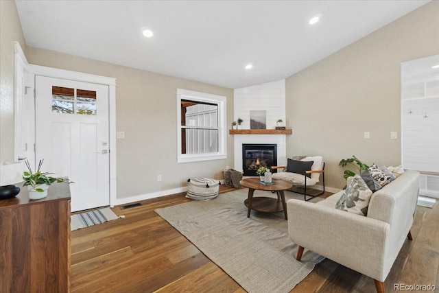 11840 Elkhorn Dr, Franktown, CO 80116 - living area featuring wood finished floors, a large fireplace, baseboards, and recessed lighting