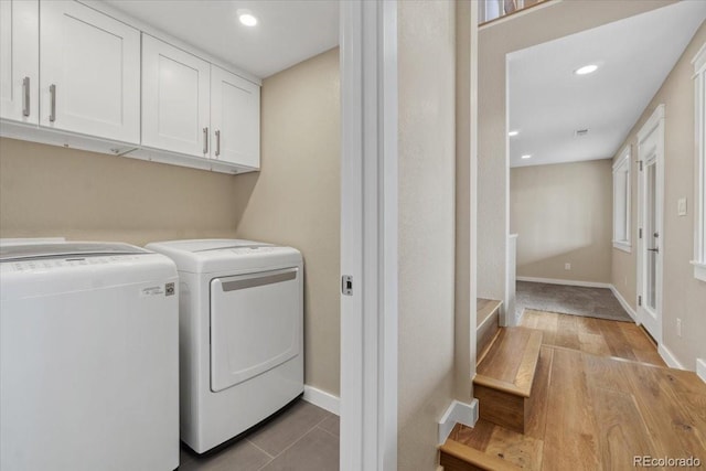 11840 Elkhorn Dr, Franktown, CO 80116 - washroom featuring washing machine and dryer, cabinet space, baseboards, recessed lighting, and light wood-style floors
