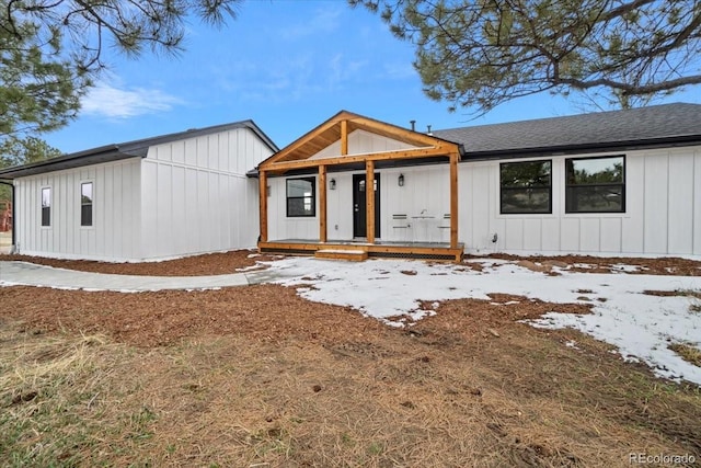 11840 Elkhorn Dr, Franktown, CO 80116 - modern farmhouse with board and batten siding, a porch, and a shingled roof