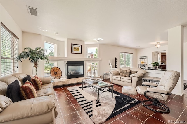 tiled living room featuring a tile fireplace