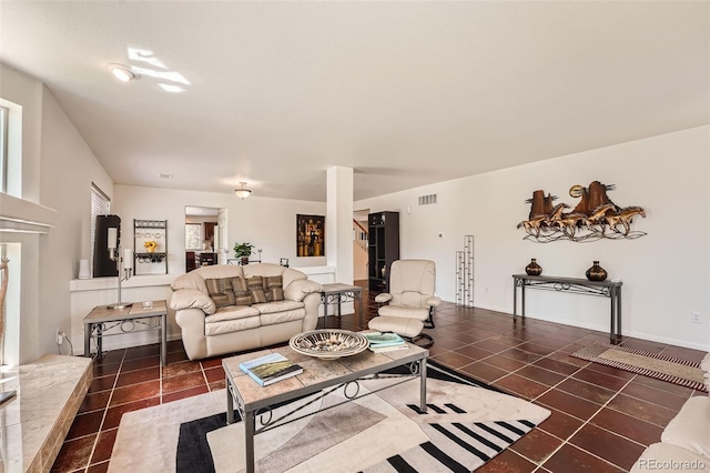 living room with plenty of natural light and dark tile patterned flooring