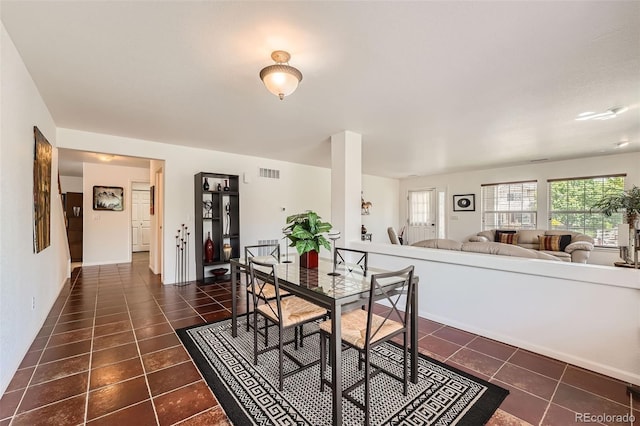 dining room with dark tile patterned floors