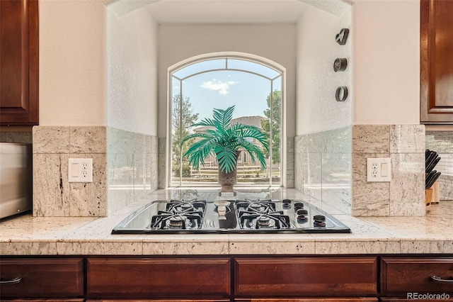 kitchen with tasteful backsplash and black gas cooktop