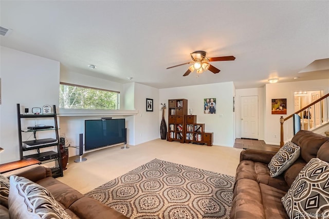 carpeted living room featuring ceiling fan