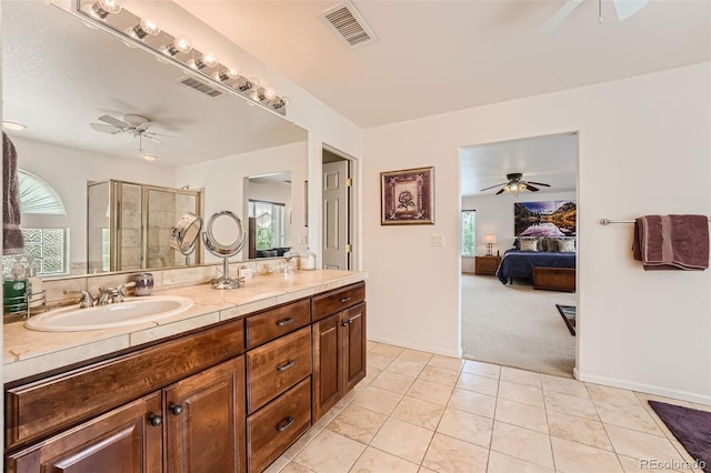 bathroom featuring tile patterned flooring, vanity, ceiling fan, and an enclosed shower