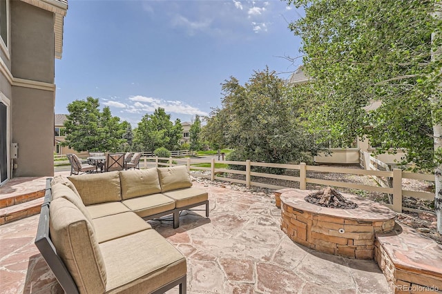 view of patio featuring an outdoor living space with a fire pit