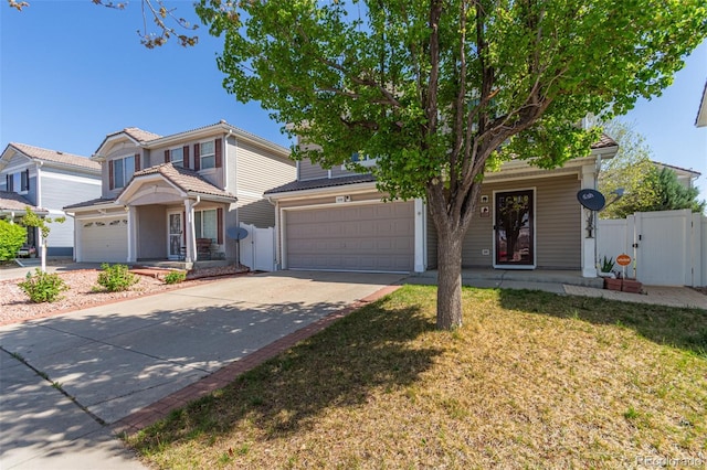 view of front of house featuring covered porch, driveway, a gate, and a garage