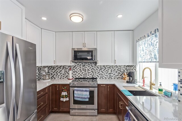 kitchen with a sink, light countertops, dark brown cabinetry, and stainless steel appliances