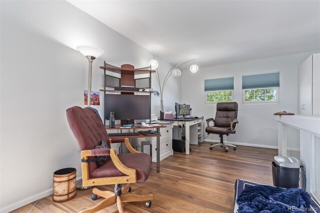 office area with baseboards and wood finished floors