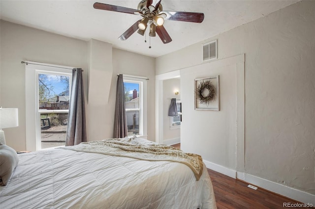 112 S Limit St, Colorado Springs, CO 80905 - bedroom with dark wood-style flooring, visible vents, baseboards, and ceiling fan