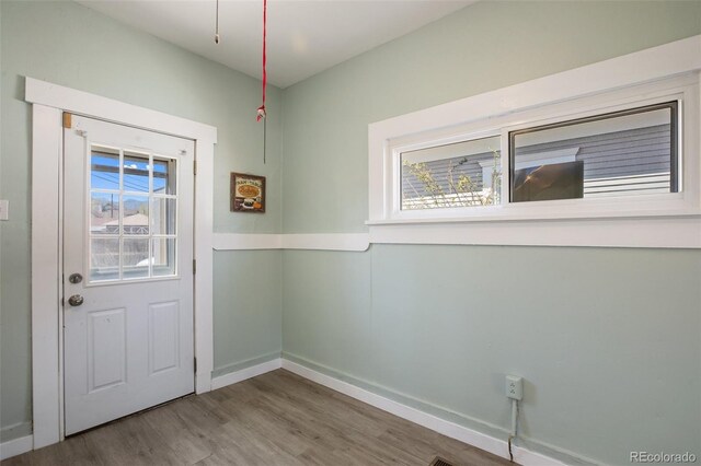 112 S Limit St, Colorado Springs, CO 80905 - doorway to outside featuring wood finished floors and baseboards