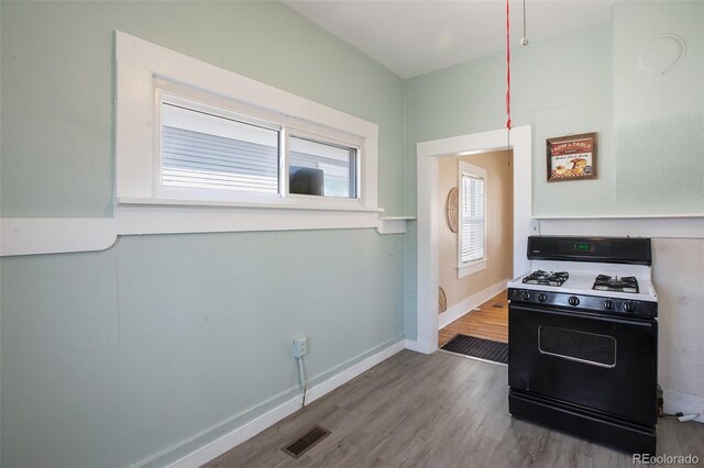 112 S Limit St, Colorado Springs, CO 80905 - kitchen with range with gas stovetop, baseboards, visible vents, and wood finished floors