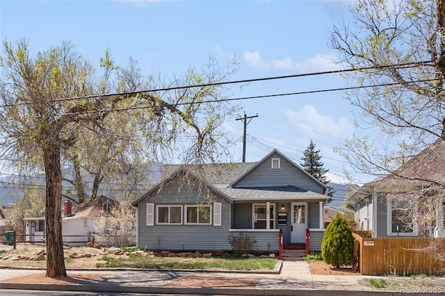112 S Limit St, Colorado Springs, CO 80905 - bungalow-style home with roof with shingles, covered porch, and a fenced front yard