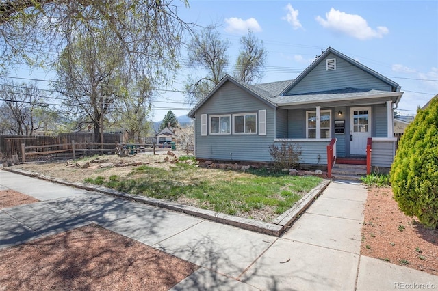 112 S Limit St, Colorado Springs, CO 80905 - bungalow-style home with a porch, fence, and a shingled roof