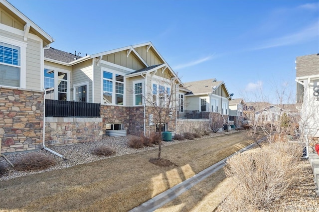 craftsman-style home featuring board and batten siding and stone siding