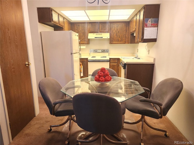 carpeted dining room with sink