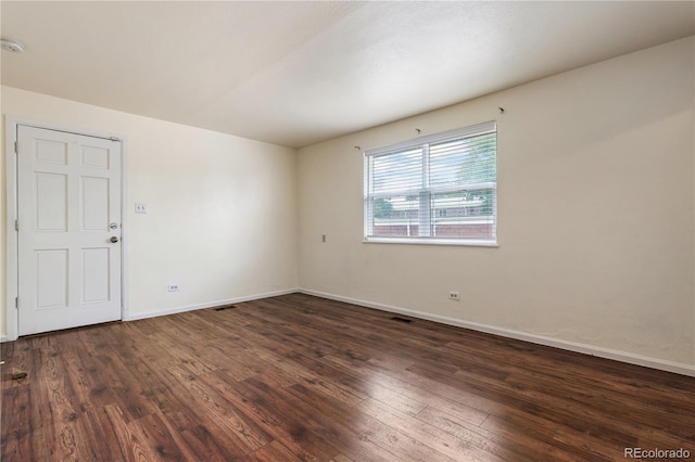 unfurnished room with dark hardwood / wood-style floors