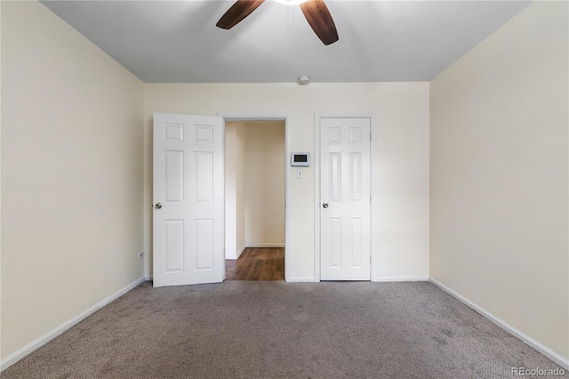 unfurnished bedroom with dark carpet, ceiling fan, and a closet