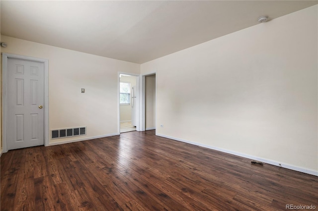 spare room featuring dark hardwood / wood-style flooring