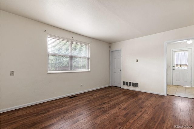 empty room with dark hardwood / wood-style floors