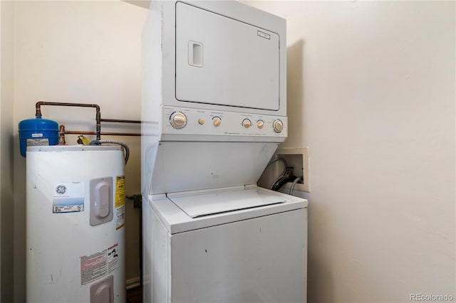 laundry room featuring electric water heater and stacked washer / drying machine