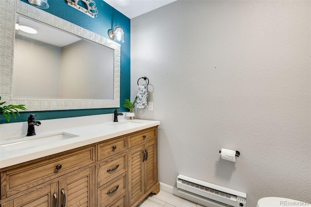 bathroom with baseboard heating, tile patterned floors, and vanity