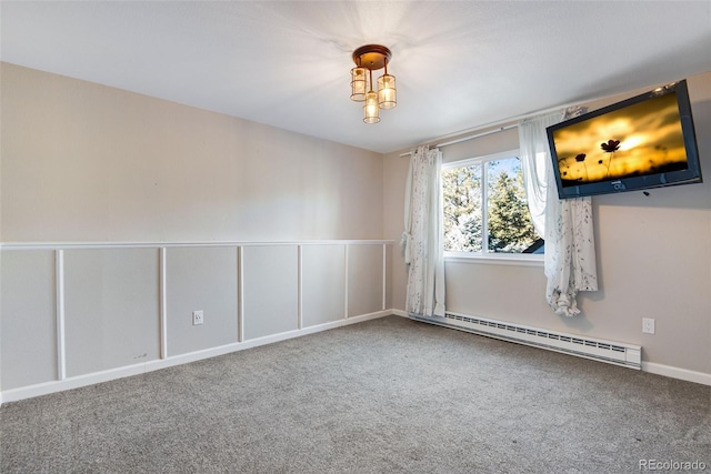 spare room featuring carpet flooring and a baseboard radiator