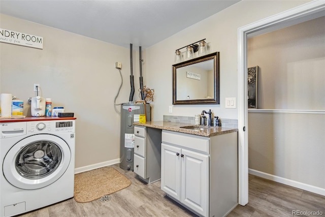 clothes washing area featuring sink, cabinets, electric water heater, light hardwood / wood-style flooring, and washer / dryer