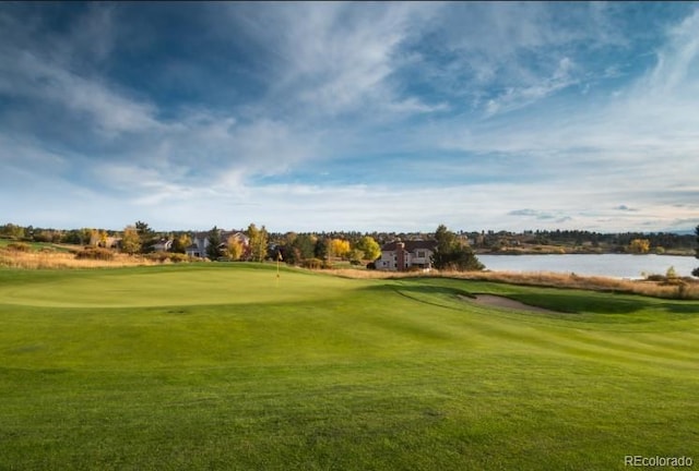 view of community with a lawn and a water view