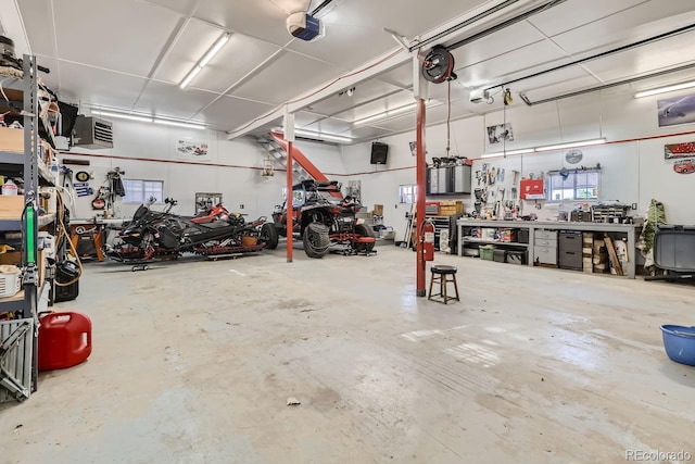 garage with a workshop area and a garage door opener