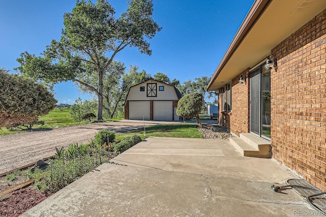 exterior space with entry steps, an outdoor structure, and a garage