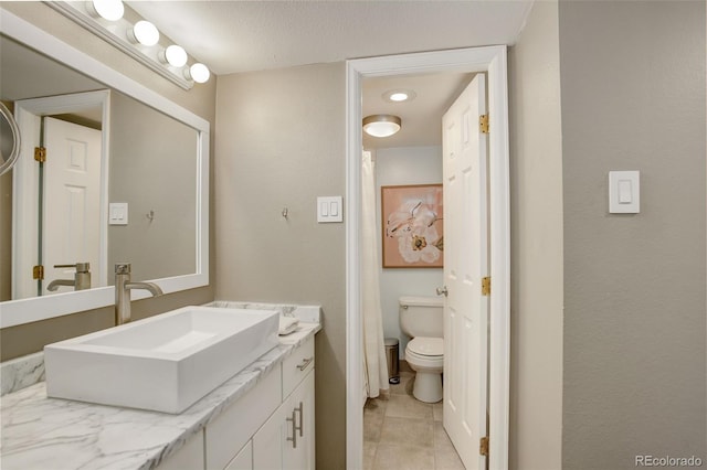 full bath featuring tile patterned floors, toilet, and vanity